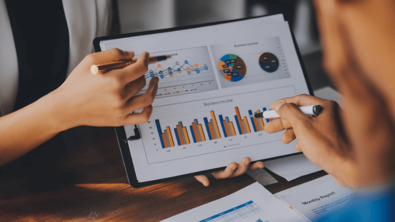 Close up of Business team analyzing income charts and graphs with modern laptop computer. Business analysis and strategy concept.